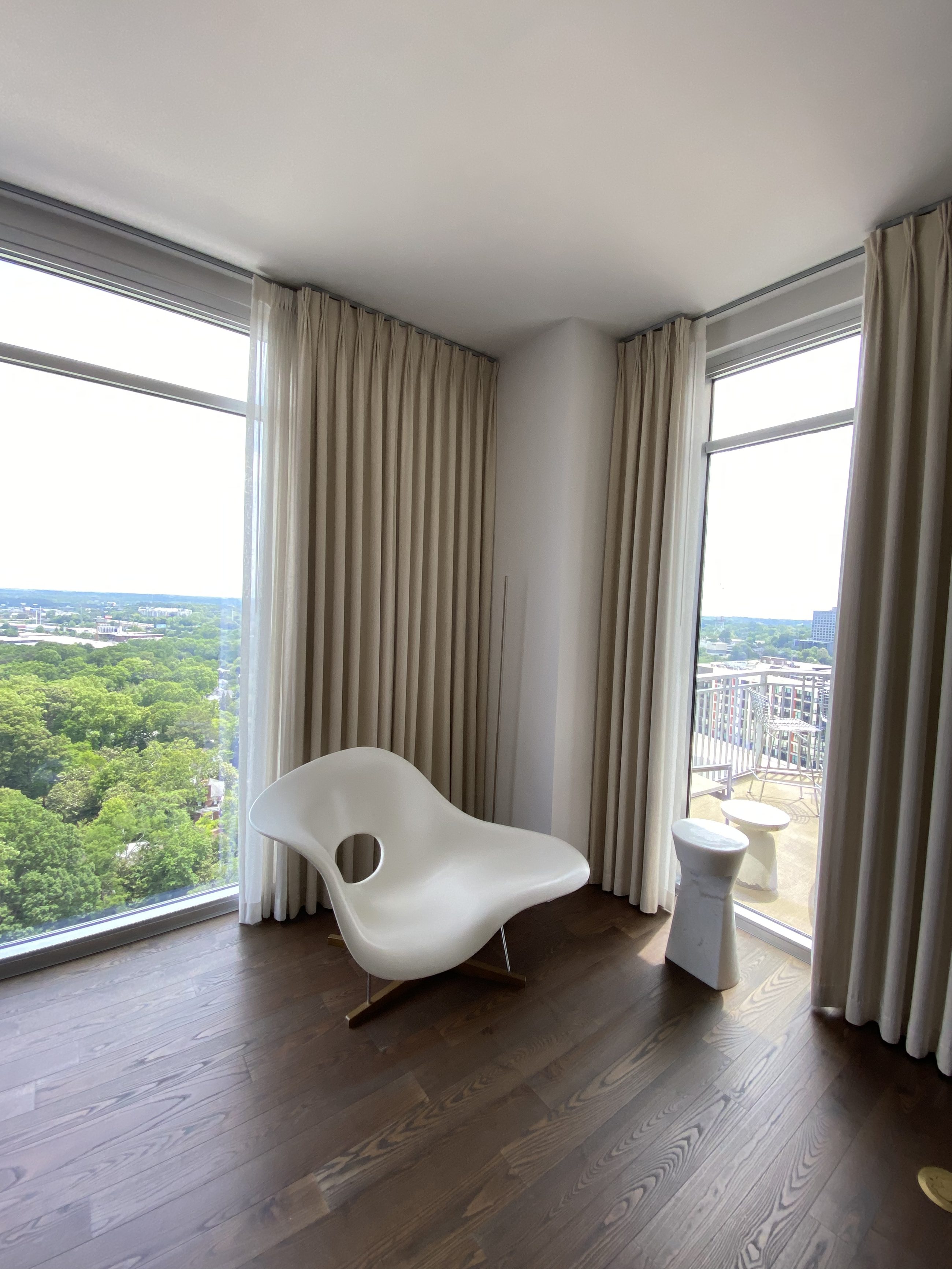 Corner of the main floor with a sculptural chaise facing the west windows