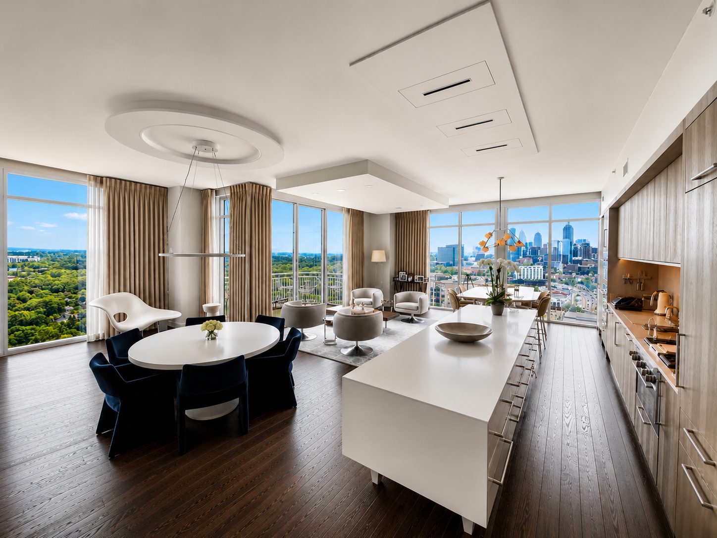 The great room of Residence 2001 with dining, living and kitchen open to floor-to-ceiling glass on two exposures
