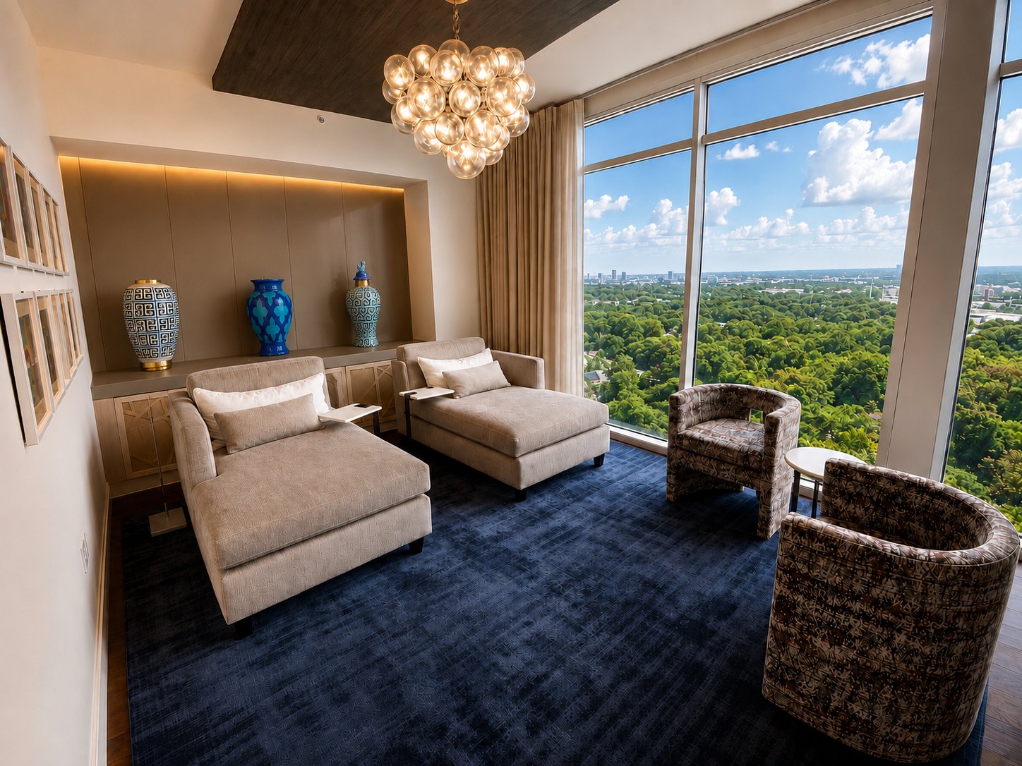 Second living room with blue silk rug, chaises and a glass bubble chandelier