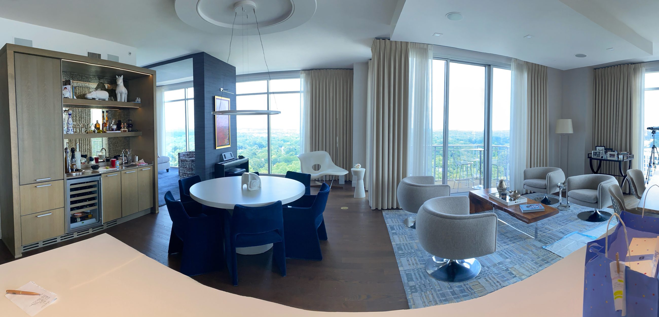 Panoramic view across the main floor showing both exposures, from the bar wall to the Downtown skyline