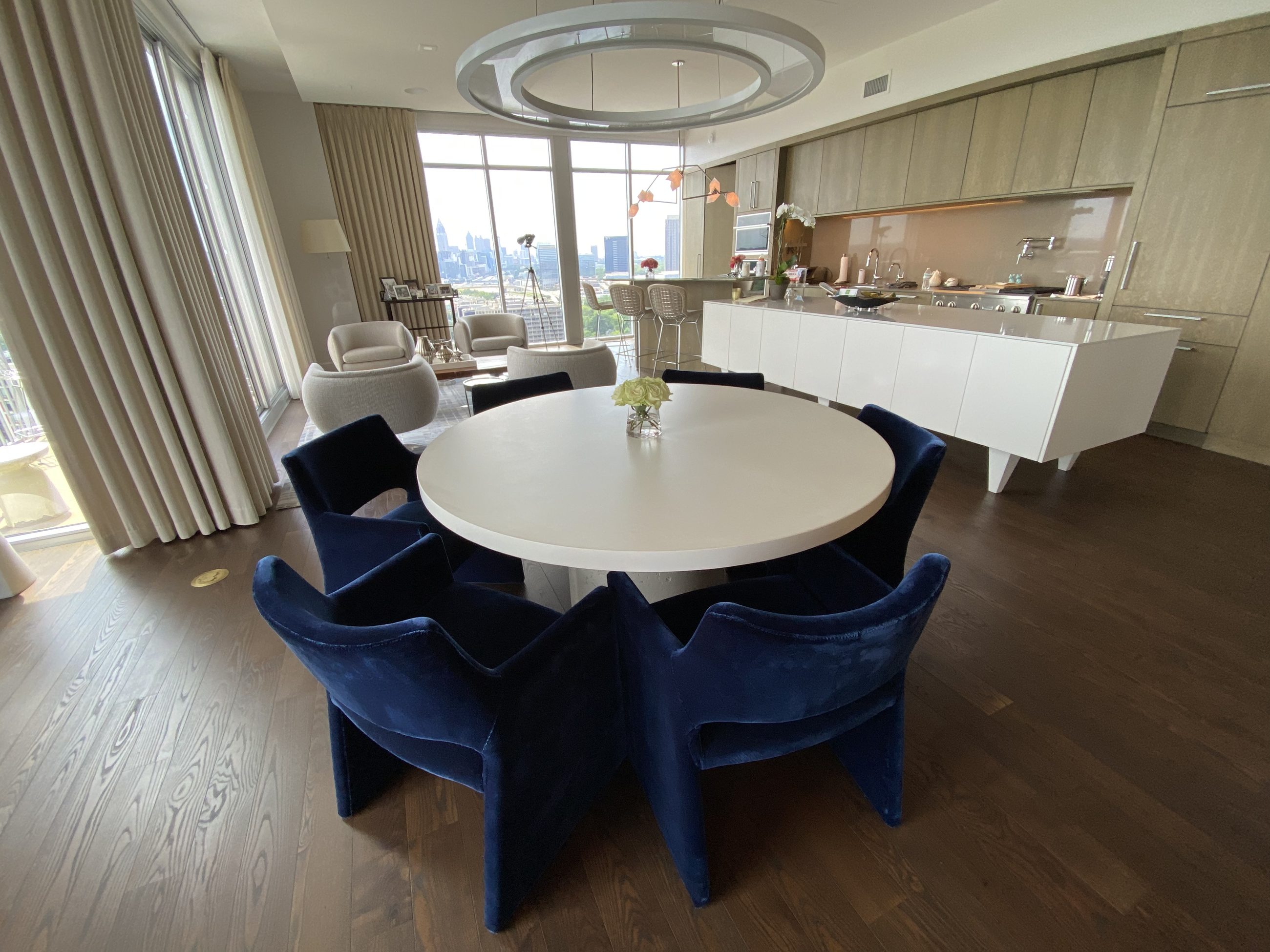 Living area with swivel chairs facing the balcony and the tree canopy west of Peachtree
